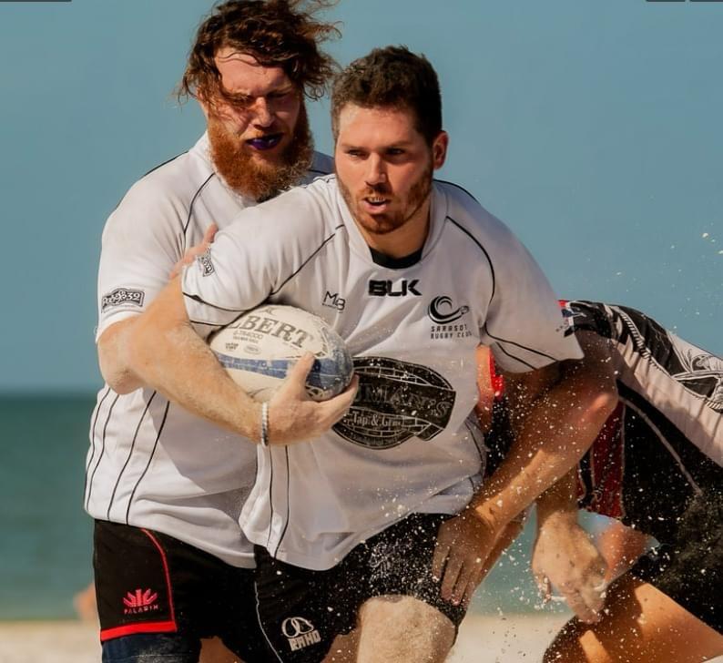 Beach rugby tackle